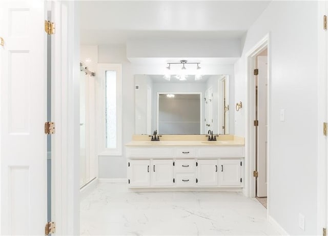 10246 Russell St, Overland Park, KS 66212 - bathroom featuring marble finish flooring, double vanity, and a stall shower