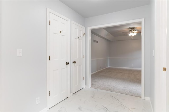 10246 Russell St, Overland Park, KS 66212 - hallway featuring light marble finish floors and baseboards