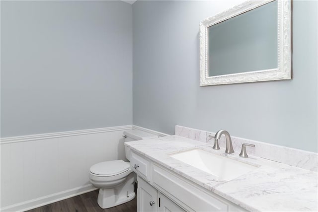 10246 Russell St, Overland Park, KS 66212 - bathroom featuring vanity, wood finished floors, and wainscoting