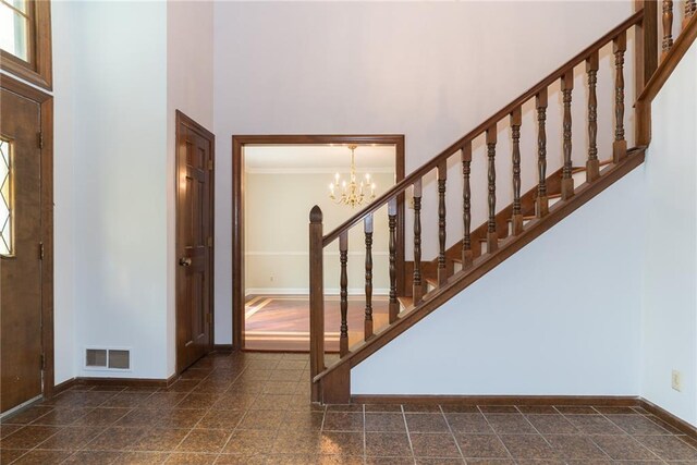 10246 Russell St, Overland Park, KS 66212 - entrance foyer with a chandelier, a towering ceiling, and stairs