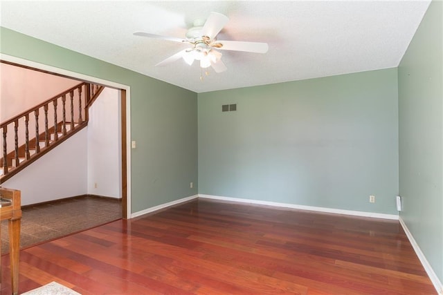 10246 Russell St, Overland Park, KS 66212 - empty room with wood finished floors, stairs, and a ceiling fan