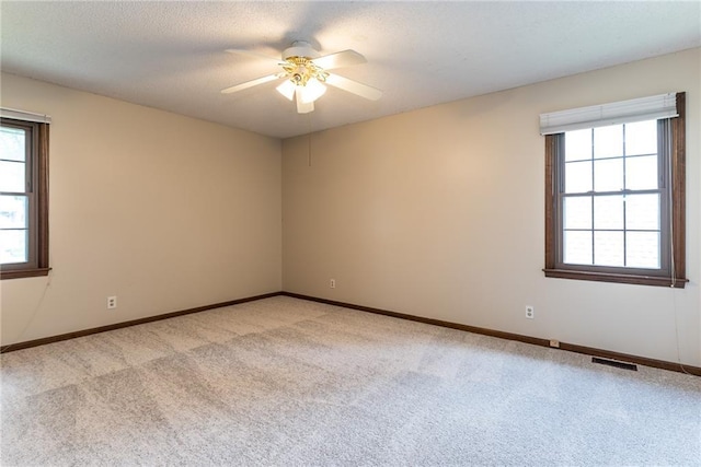 10246 Russell St, Overland Park, KS 66212 - unfurnished room with light carpet, ceiling fan, and a textured ceiling