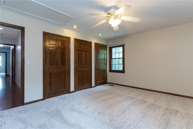 10246 Russell St, Overland Park, KS 66212 - unfurnished bedroom with attic access, carpet floors, two closets, recessed lighting, and ceiling fan