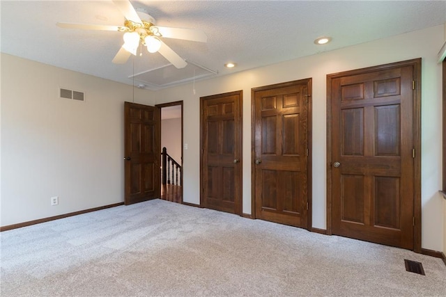 10246 Russell St, Overland Park, KS 66212 - unfurnished bedroom with attic access, carpet floors, multiple closets, recessed lighting, and ceiling fan