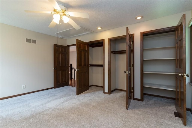10246 Russell St, Overland Park, KS 66212 - unfurnished bedroom featuring attic access, light carpet, a textured ceiling, two closets, and a ceiling fan