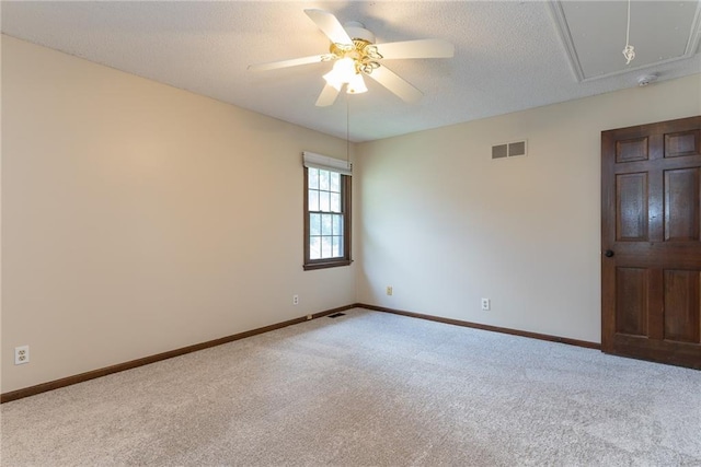 10246 Russell St, Overland Park, KS 66212 - carpeted spare room with attic access, a ceiling fan, and a textured ceiling
