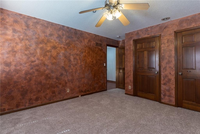 10246 Russell St, Overland Park, KS 66212 - unfurnished bedroom featuring carpet flooring, a textured ceiling, and ceiling fan