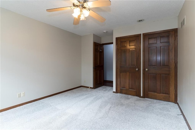 10246 Russell St, Overland Park, KS 66212 - unfurnished bedroom with light carpet, a textured ceiling, and ceiling fan