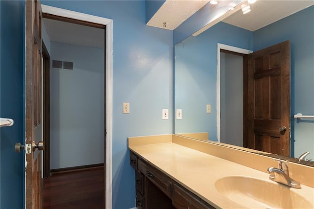 10246 Russell St, Overland Park, KS 66212 - bathroom with wood finished floors and vanity