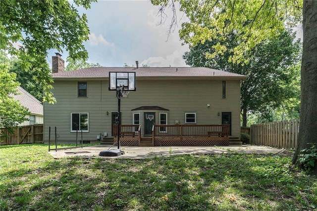 10246 Russell St, Overland Park, KS 66212 - rear view of house with a fenced backyard, a deck, a chimney, and a patio