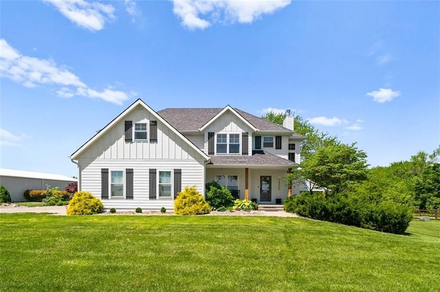 14906 Knorpp Rd, Pleasant Hill, MO 64080 - view of front of house featuring board and batten siding, a front lawn, and a chimney