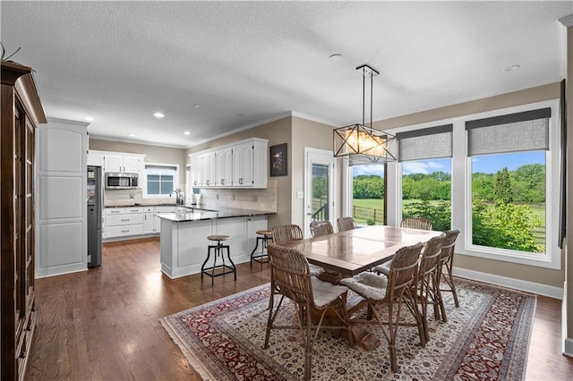 14906 Knorpp Rd, Pleasant Hill, MO 64080 - dining area featuring crown molding, dark wood finished floors, a textured ceiling, and recessed lighting