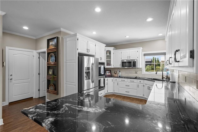 14906 Knorpp Rd, Pleasant Hill, MO 64080 - kitchen with stainless steel appliances, a peninsula, ornamental molding, decorative backsplash, and recessed lighting