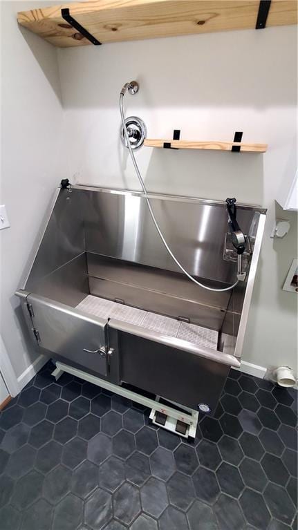14906 Knorpp Rd, Pleasant Hill, MO 64080 - detailed view of pet washing area and baseboards