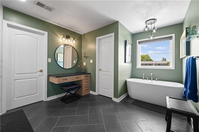 14906 Knorpp Rd, Pleasant Hill, MO 64080 - bathroom with a freestanding bath, tile patterned flooring, a textured ceiling, and vanity