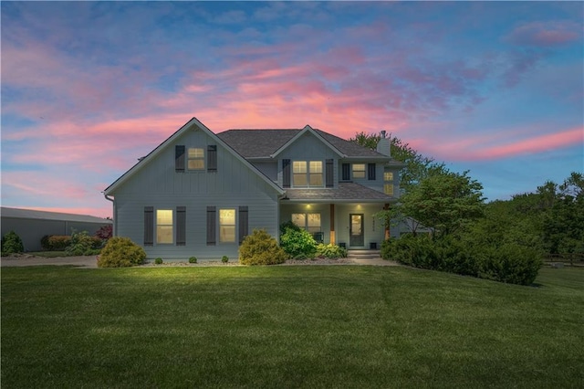 14906 Knorpp Rd, Pleasant Hill, MO 64080 - view of front facade with a chimney, a yard, covered porch, and board and batten siding