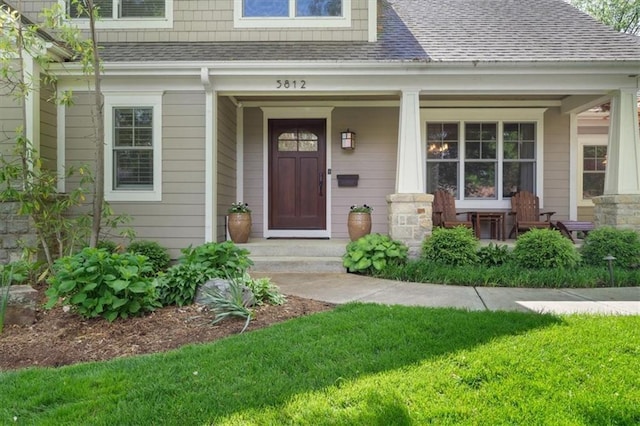 5812 Reinhardt Dr, Fairway, KS 66205 - property entrance featuring roof with shingles, a porch, and a lawn