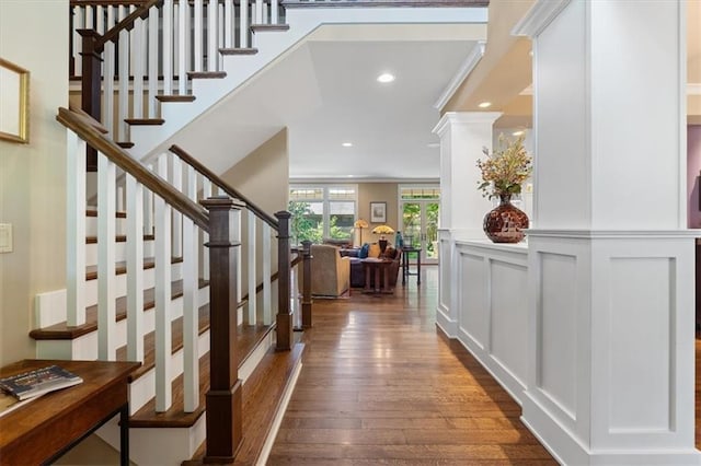 5812 Reinhardt Dr, Fairway, KS 66205 - entrance foyer featuring dark wood-style floors, stairs, recessed lighting, ornamental molding, and a decorative wall