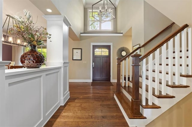 5812 Reinhardt Dr, Fairway, KS 66205 - entrance foyer featuring a chandelier, dark wood-style flooring, stairs, a high ceiling, and baseboards