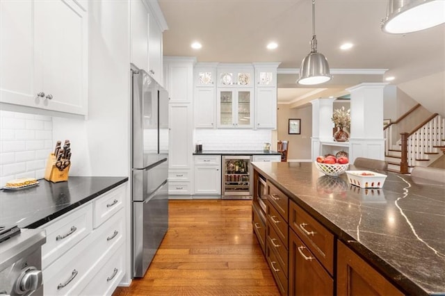 5812 Reinhardt Dr, Fairway, KS 66205 - kitchen featuring appliances with stainless steel finishes, beverage cooler, white cabinetry, recessed lighting, and crown molding