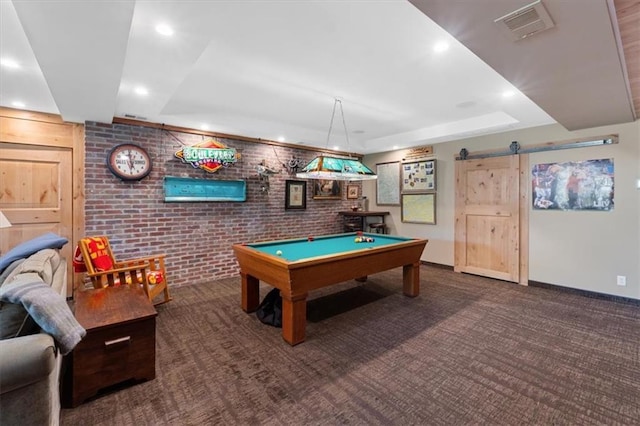 5812 Reinhardt Dr, Fairway, KS 66205 - recreation room featuring brick wall, a barn door, a raised ceiling, carpet floors, and recessed lighting