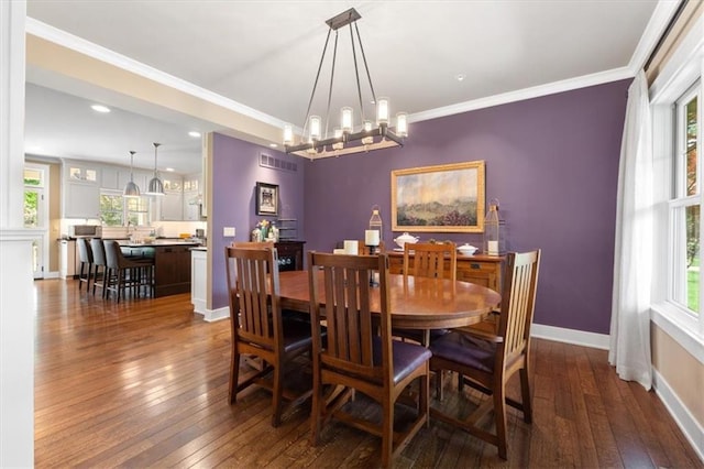 5812 Reinhardt Dr, Fairway, KS 66205 - dining room featuring dark wood finished floors, healthy amount of natural light, baseboards, a chandelier, and ornamental molding