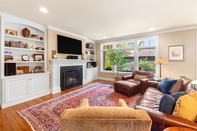 5812 Reinhardt Dr, Fairway, KS 66205 - living area featuring hardwood / wood-style flooring, a lit fireplace, crown molding, built in features, and recessed lighting