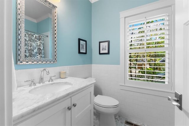 5812 Reinhardt Dr, Fairway, KS 66205 - full bathroom featuring tile walls, vanity, toilet, a wainscoted wall, and tile patterned flooring