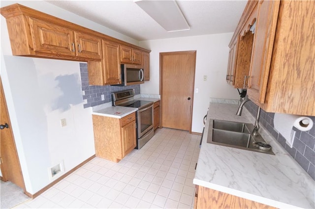 500 Valley View Dr, Frontenac, KS 66763 - kitchen with stainless steel appliances, decorative backsplash, light countertops, and brown cabinets