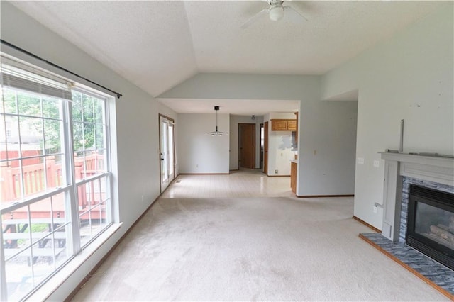 500 Valley View Dr, Frontenac, KS 66763 - unfurnished living room with light carpet, a tile fireplace, lofted ceiling, a ceiling fan, and a textured ceiling