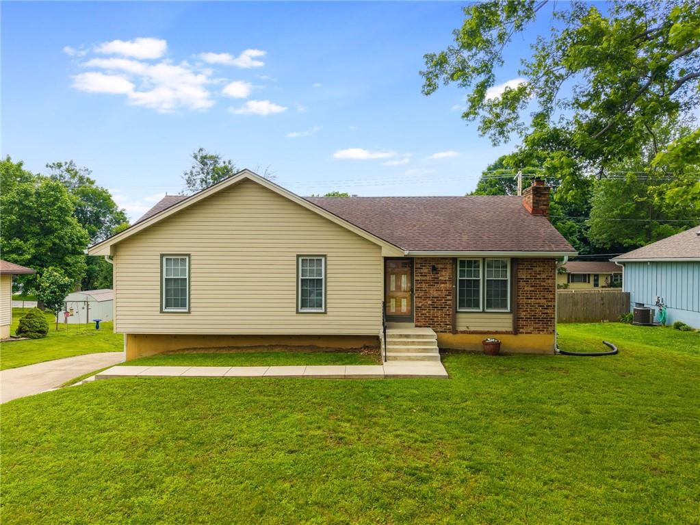 8707 Brenda Ln, Pleasant Valley, MO 64068 - single story home featuring a chimney, brick siding, and cooling unit