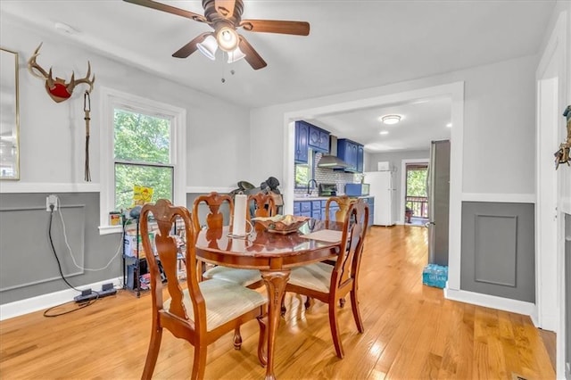 8303 Wabash Ave, Kansas City, MO 64132 - dining space featuring light wood-style flooring, ceiling fan, and healthy amount of natural light