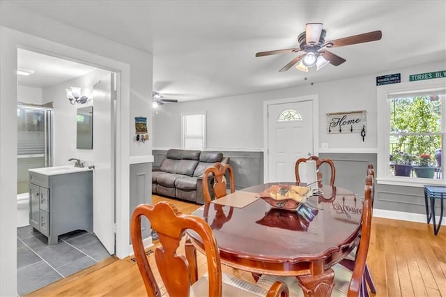 8303 Wabash Ave, Kansas City, MO 64132 - dining area with ceiling fan, healthy amount of natural light, and light wood finished floors