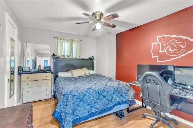 8303 Wabash Ave, Kansas City, MO 64132 - bedroom with wood finished floors, a ceiling fan, and a desk