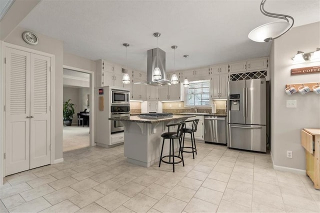 8410 W 117th St, Overland Park, KS 66210 - kitchen featuring stainless steel appliances, island range hood, a kitchen breakfast bar, a center island, and pendant lighting
