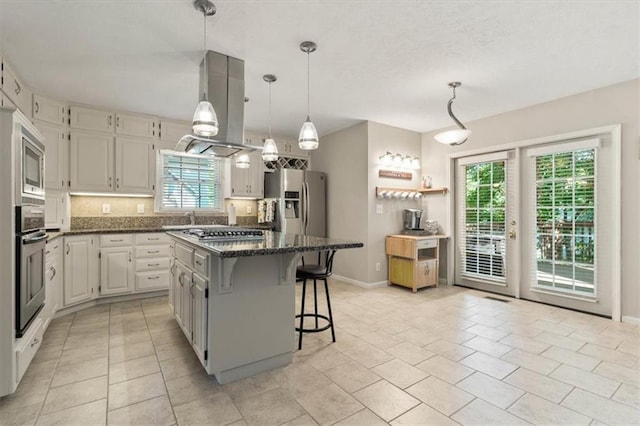 8410 W 117th St, Overland Park, KS 66210 - kitchen with a kitchen island, appliances with stainless steel finishes, island range hood, a breakfast bar, and decorative backsplash