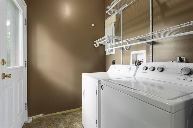 10203 Outer Rd, Odessa, MO 64076 - laundry area featuring washer and dryer and dark stone finish flooring