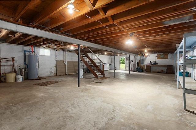 10203 Outer Rd, Odessa, MO 64076 - below grade area featuring water heater, stairway, and healthy amount of natural light