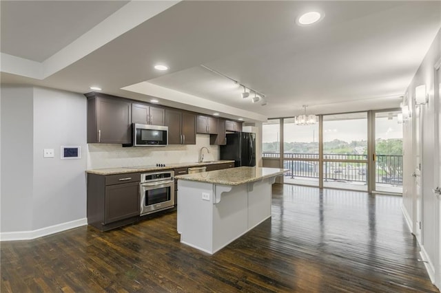 600 E Admiral Blvd Unit 601, Kansas City, MO 64106 - kitchen with black appliances, dark wood-style flooring, baseboards, backsplash, and floor to ceiling windows