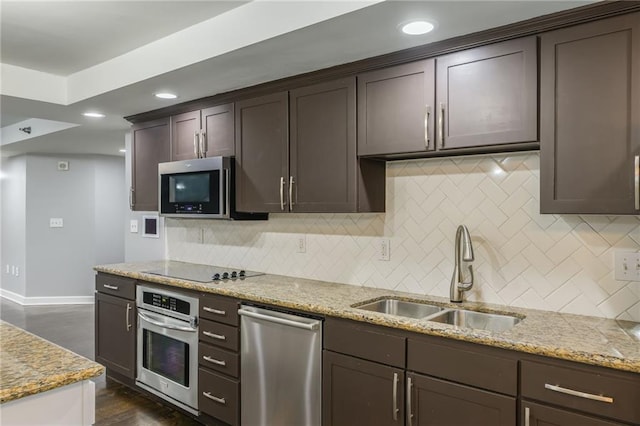 600 E Admiral Blvd Unit 601, Kansas City, MO 64106 - kitchen featuring appliances with stainless steel finishes, a sink, decorative backsplash, light stone countertops, and recessed lighting