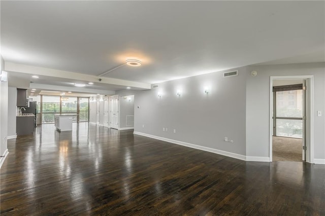600 E Admiral Blvd Unit 601, Kansas City, MO 64106 - spare room featuring baseboards and dark wood-style flooring
