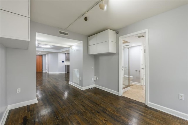 600 E Admiral Blvd Unit 601, Kansas City, MO 64106 - spare room with dark wood-style floors, baseboards, and track lighting