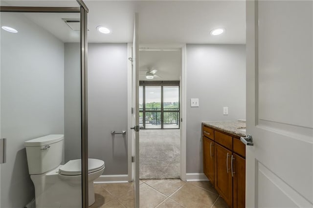 600 E Admiral Blvd Unit 601, Kansas City, MO 64106 - bathroom featuring vanity, toilet, ceiling fan, tile patterned floors, and baseboards