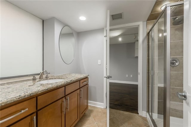 600 E Admiral Blvd Unit 601, Kansas City, MO 64106 - bathroom with vanity, a stall shower, tile patterned floors, and baseboards