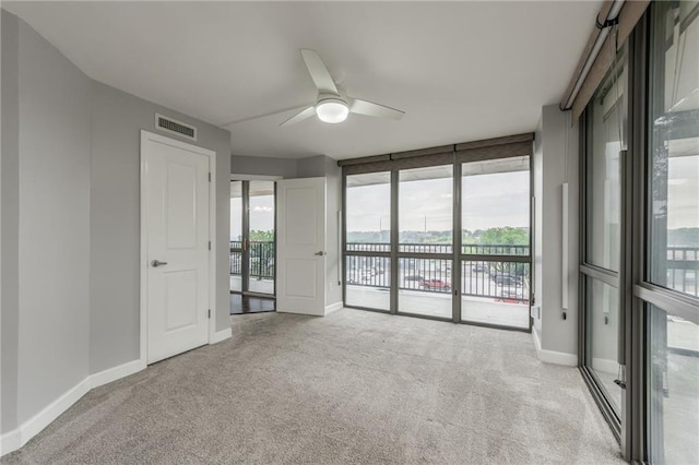 600 E Admiral Blvd Unit 601, Kansas City, MO 64106 - carpeted empty room with a water view, a ceiling fan, plenty of natural light, baseboards, and floor to ceiling windows