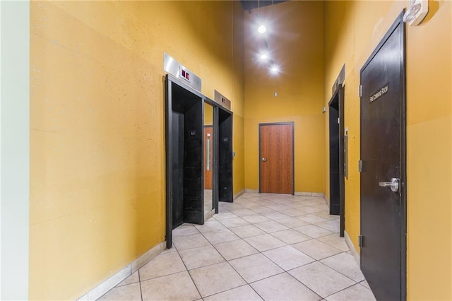 600 E Admiral Blvd Unit 601, Kansas City, MO 64106 - corridor featuring a high ceiling, light tile patterned floors, and baseboards