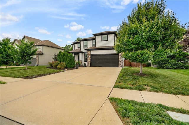 16154 S Canton St, Gardner, KS 66030 - view of front of home featuring an attached garage, concrete driveway, a front yard, stone siding, and a residential view