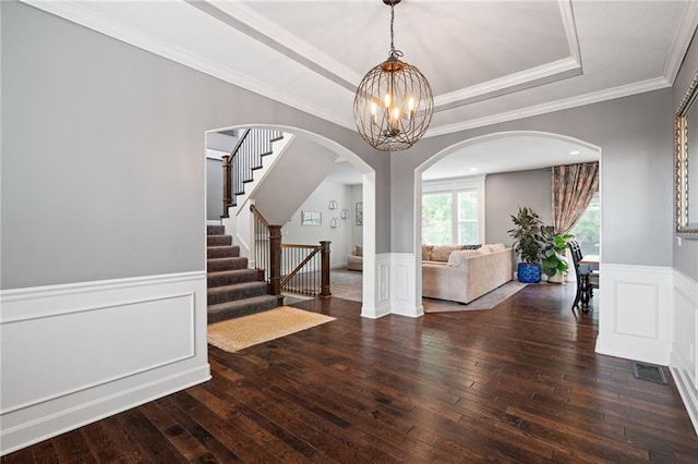 16154 S Canton St, Gardner, KS 66030 - entryway featuring stairway, hardwood / wood-style flooring, wainscoting, arched walkways, and a chandelier