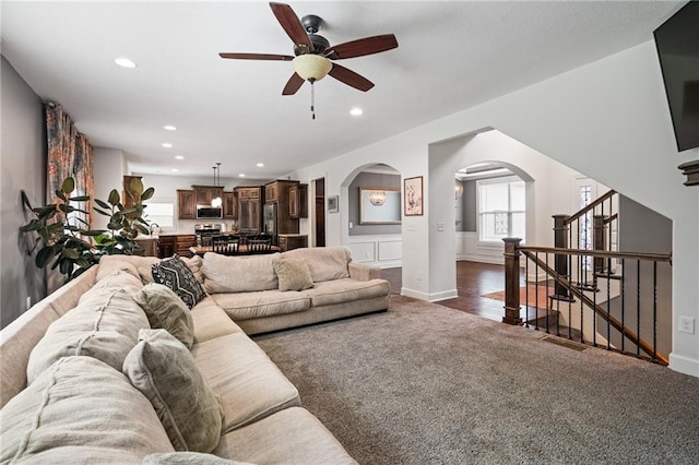 16154 S Canton St, Gardner, KS 66030 - living room featuring arched walkways, dark colored carpet, ceiling fan, recessed lighting, and stairway