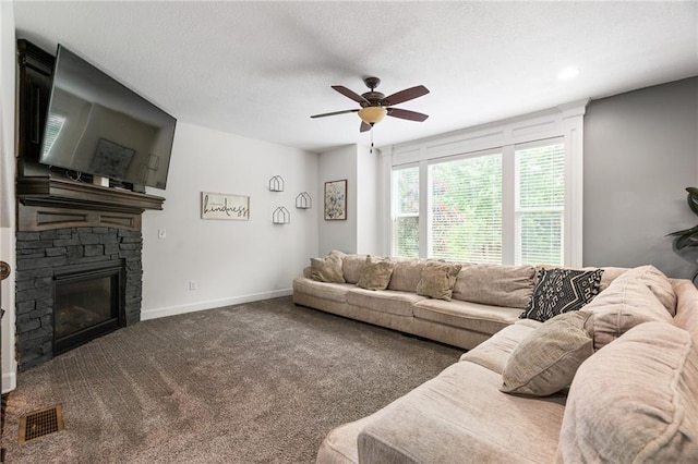 16154 S Canton St, Gardner, KS 66030 - carpeted living area featuring a stone fireplace, ceiling fan, and recessed lighting